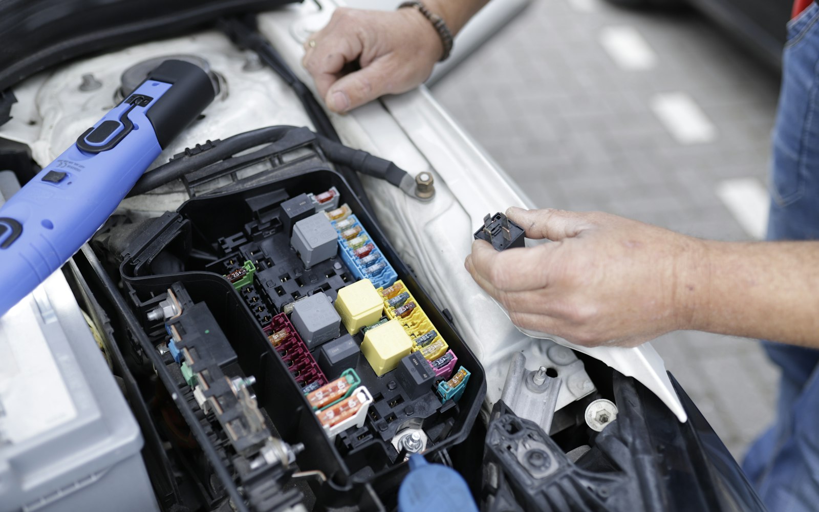 Technician working in a vehicle engine bay