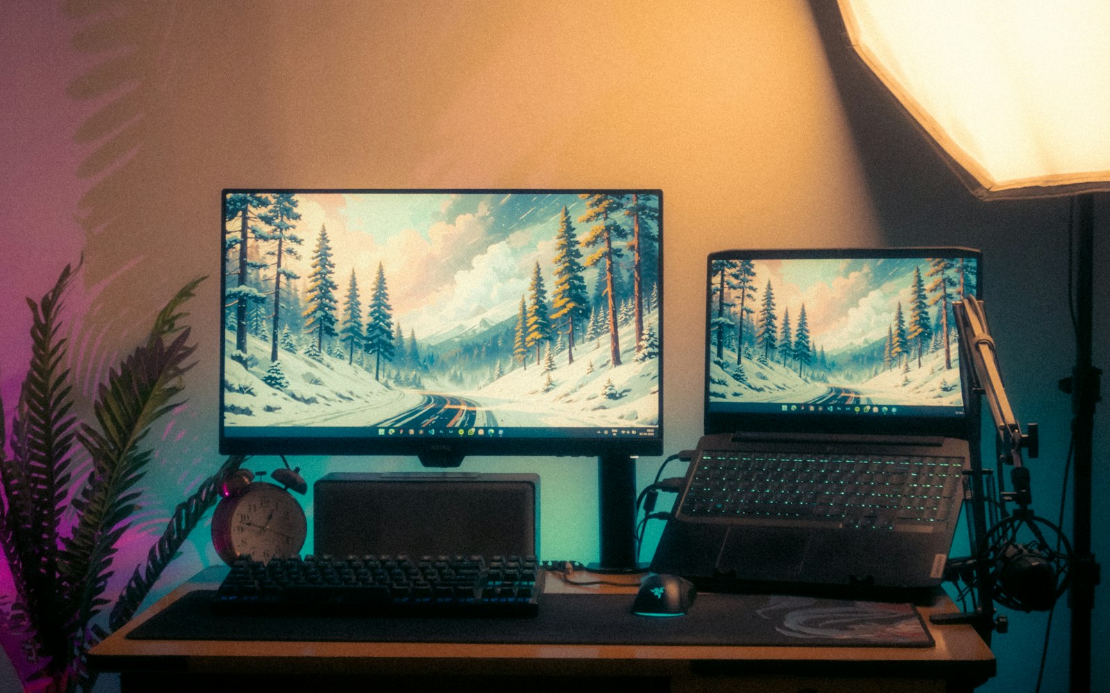 Desk with two monitors in a softly lit room
