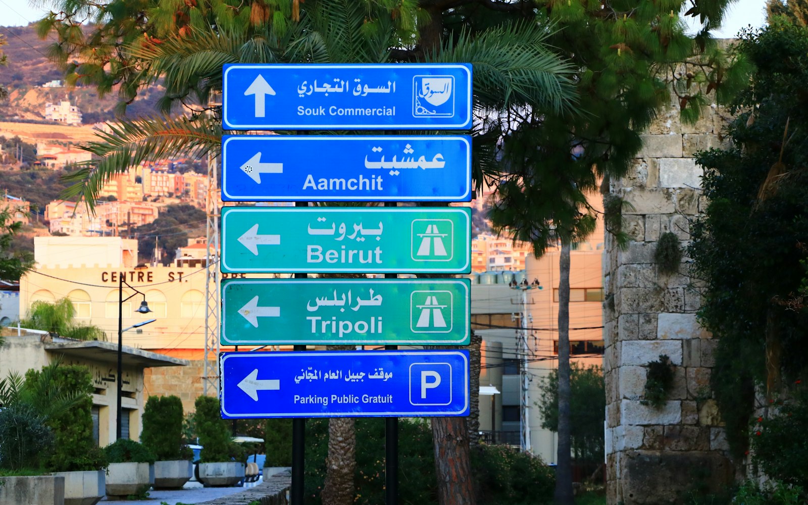 Blue and green road signs pointing in different directions
