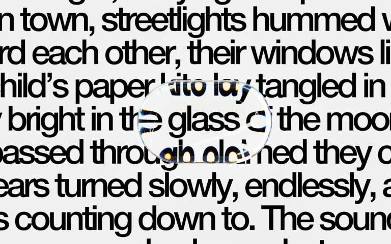 A magnifying glass distorting a block of printed text